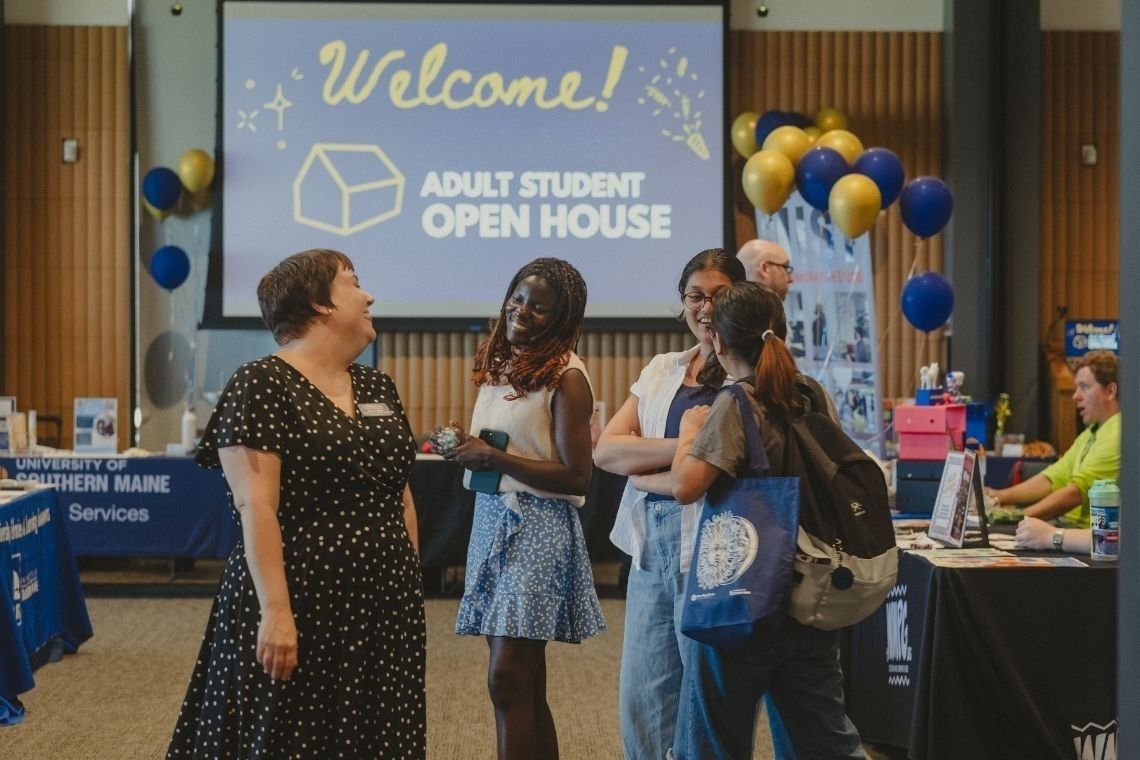 Gina Capra chatting with students at a previous Adult Students Open House at USM.