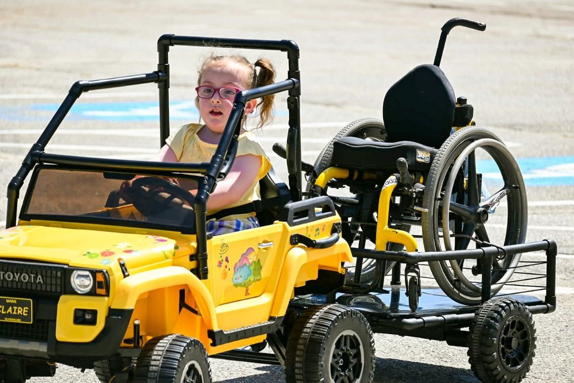 Claire driving her newly adapted car with wheel chair in tow.