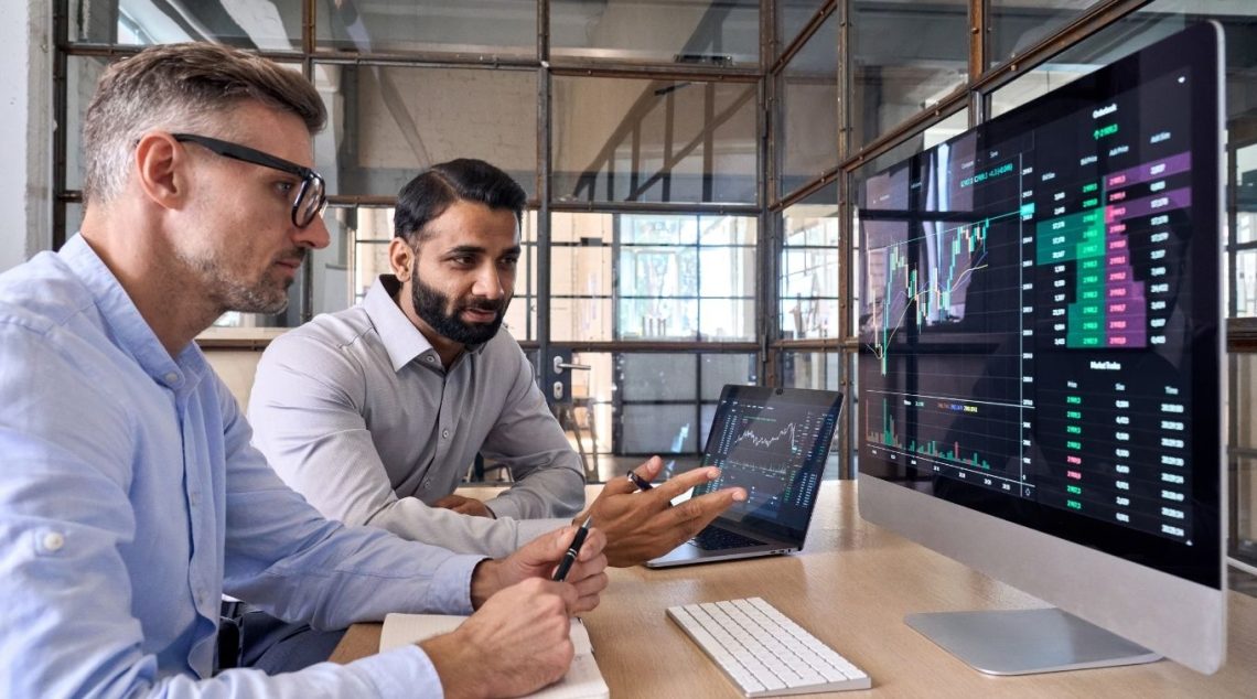 Two market research analysts looking over data sets.