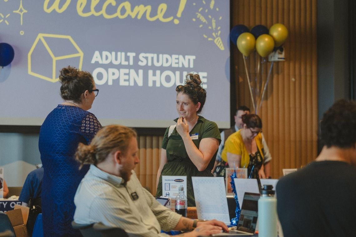 Chelsea Verria chatting with student resources at the 2nd annual Adult Student Open House at USM.