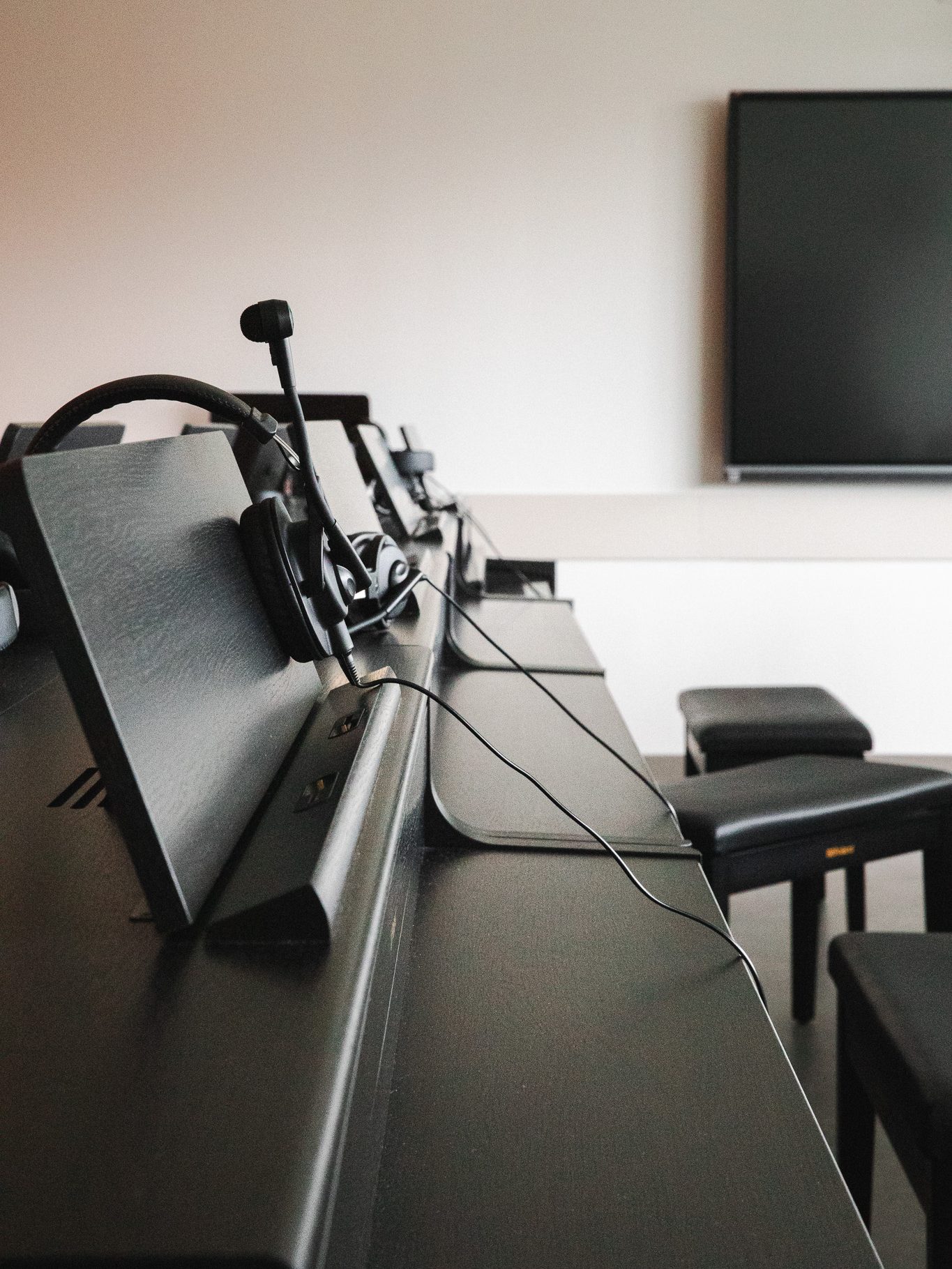 Production headsets lined up on a desk in the Crewe Center's control room.