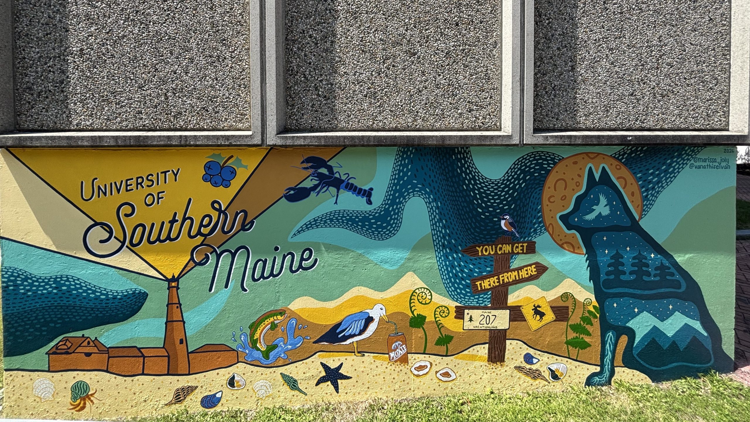 The finished Southern Maine mural on Luther Bonney Hall, with a lighthouse, a blue lobster, a seagull sipping Moxie, and a husky silhouette beneath script lettering that reads “University of Southern Maine.”