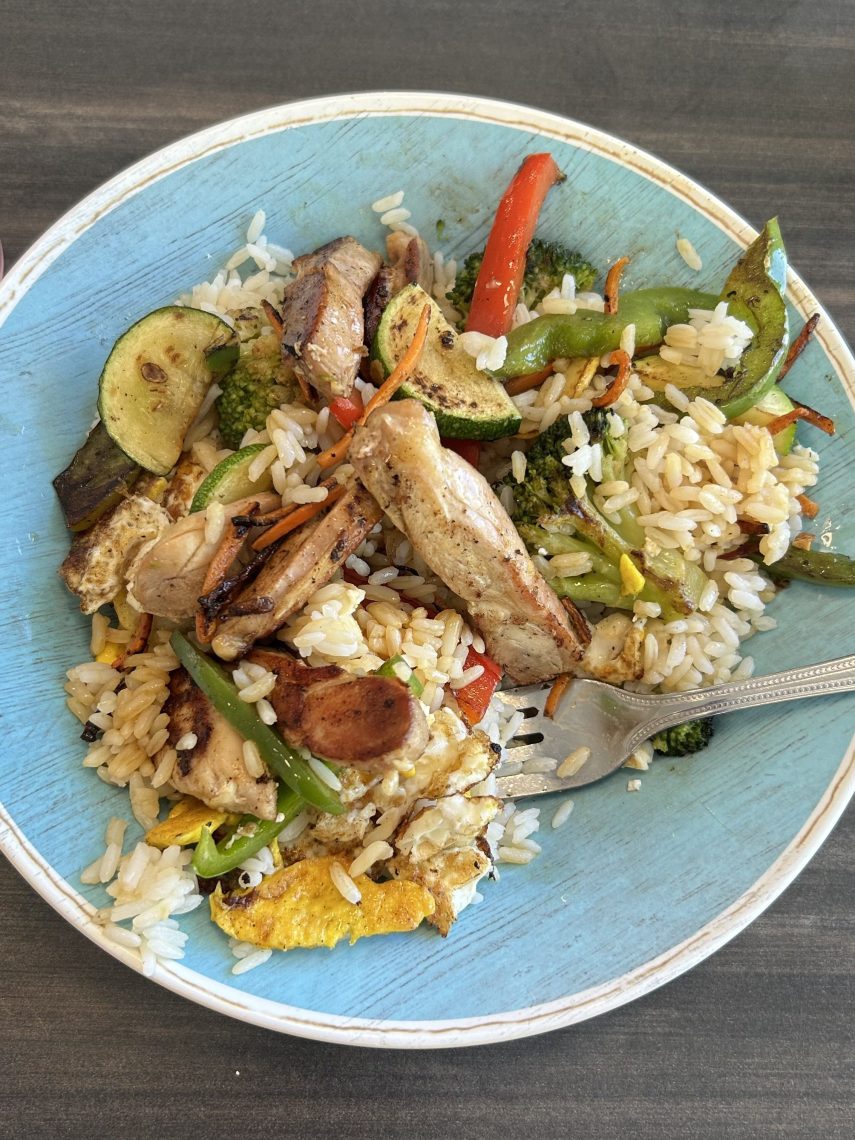 A plate of fried rice with grilled chicken, egg, zucchini, broccoli, carrots, and red and green peppers from the wok bar at Brooks Dining Hall.