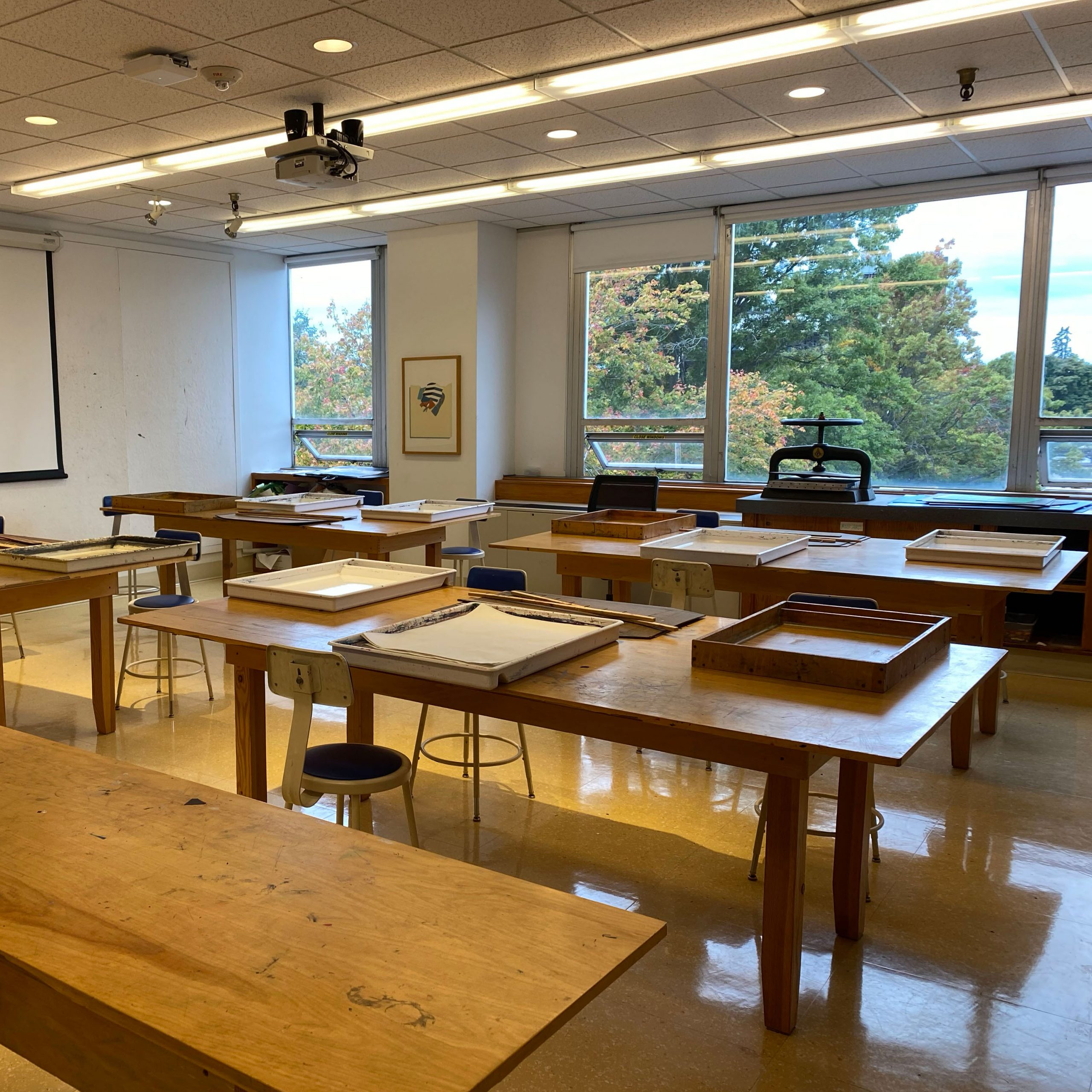 Photograph of an empty classroom full of bookmaking tools for future projects.