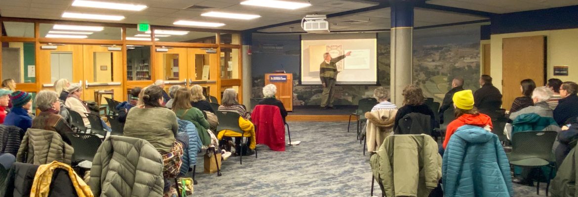 Photograph of an artist lecture by Reid Byers, with an audience of book arts enthusiasts.