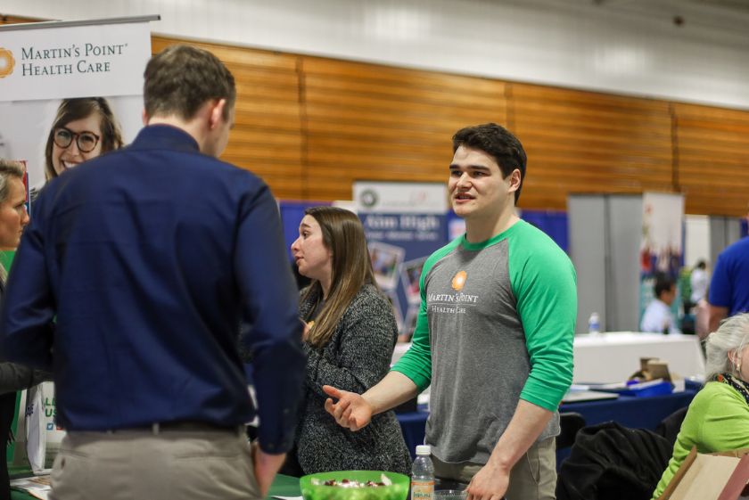 Students talk to a company representative during the spring 2020 USM Job Fair