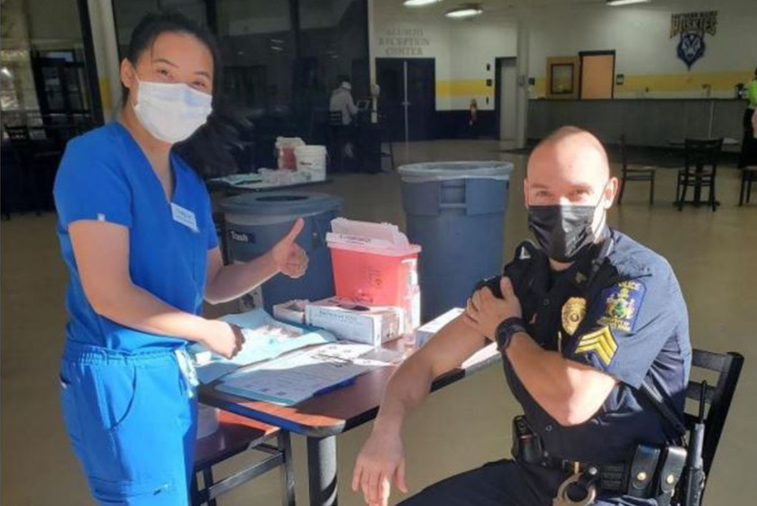 A campus police officer getting a flu shot from a nursing student at one of our flu clinics.