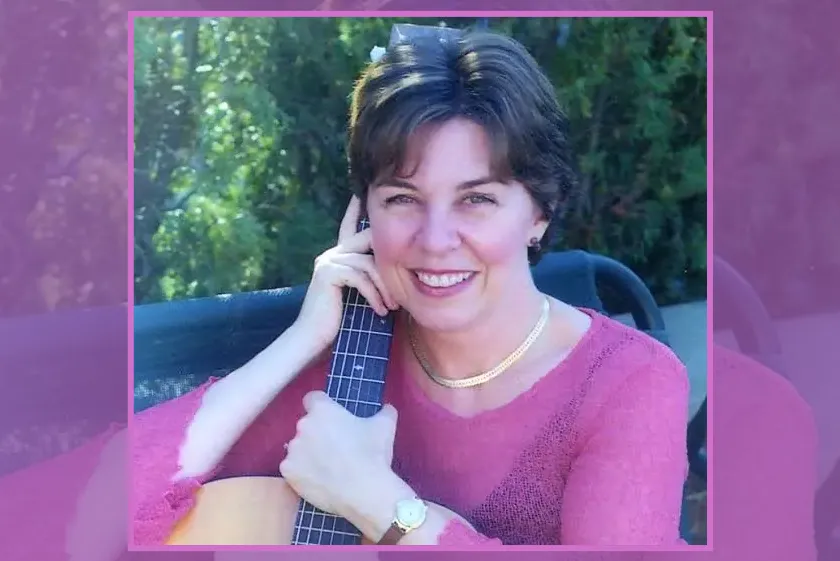 A headshot of Josée Vachon with an acoustic guitar.