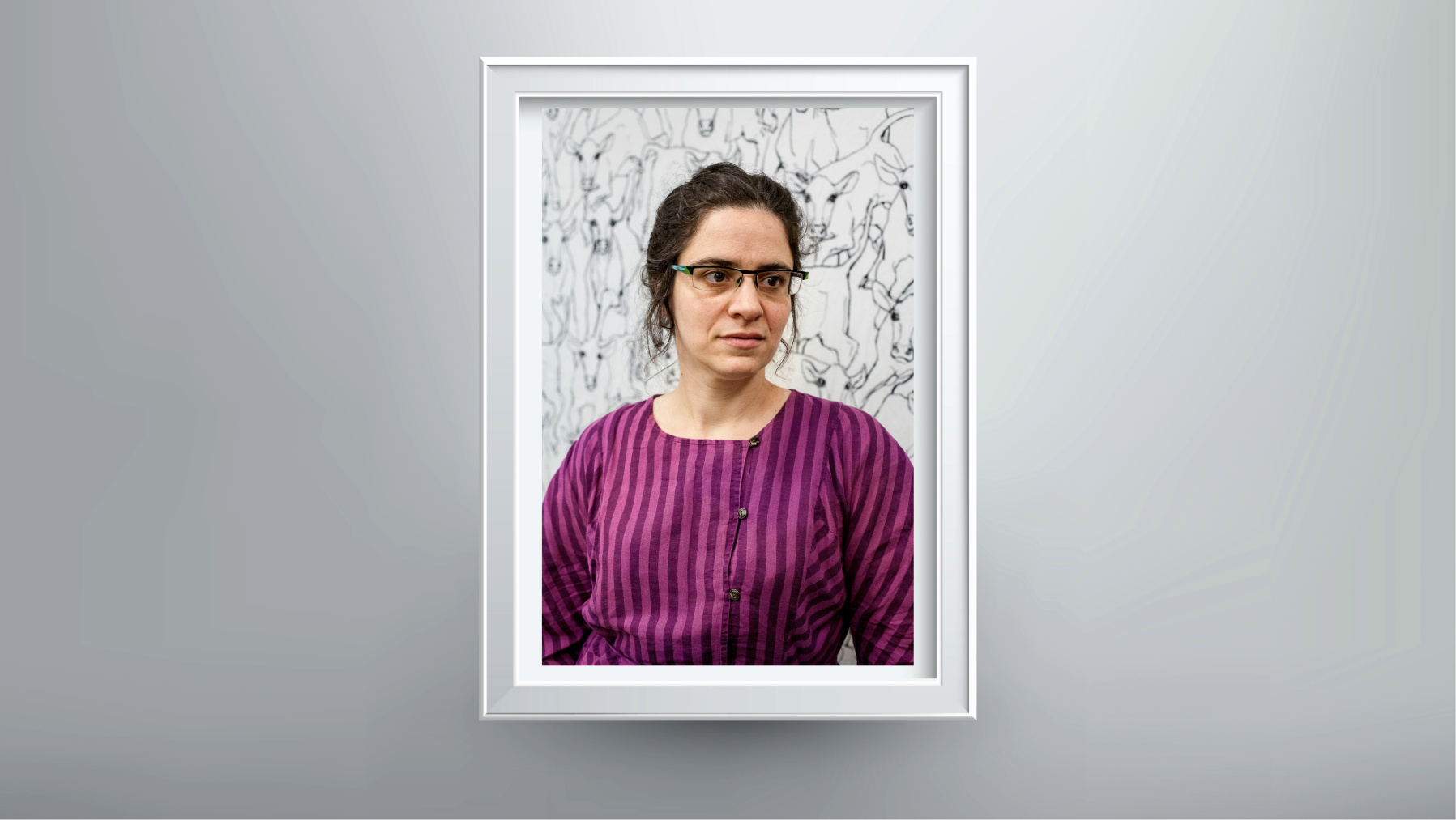 Professor Agnes Callard headshot shown in a frame on a gray wall