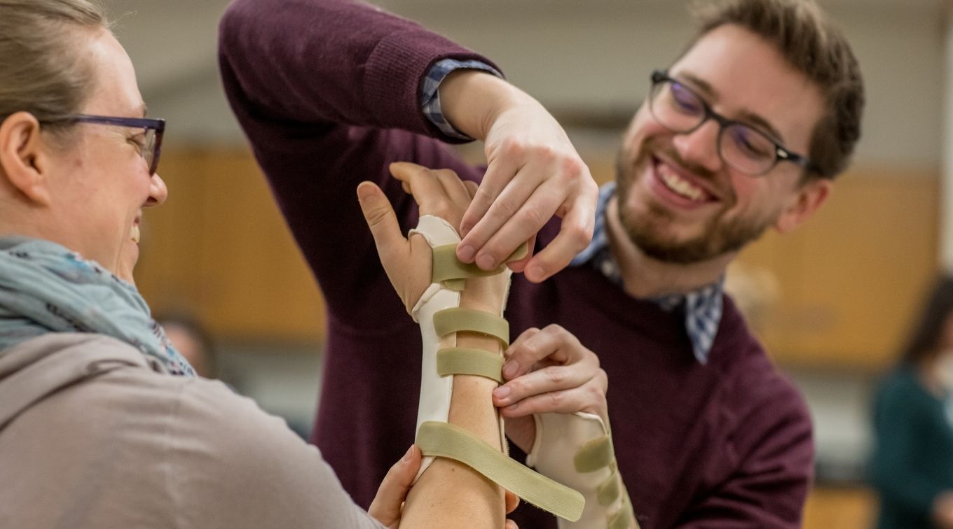 Occupational Therapy students practicing proper wrist brace application.