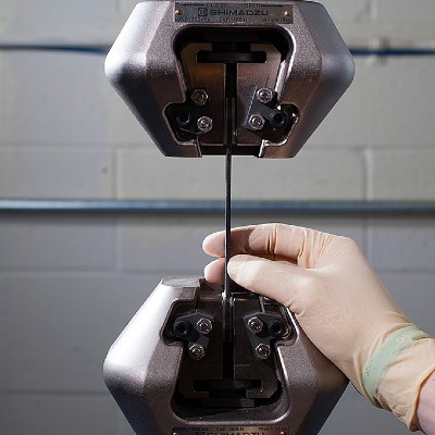 Positioning a sample in a tensile testing machine for strength and durability analysis