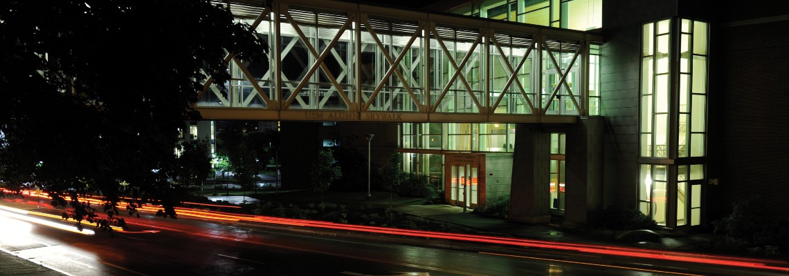 The front of the Abromson Center illuminated at night.