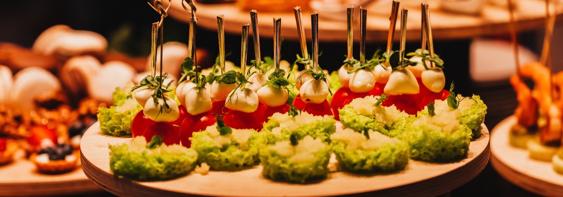 A display of appetizers made from tomatoes, fresh basil, and mozzarella.