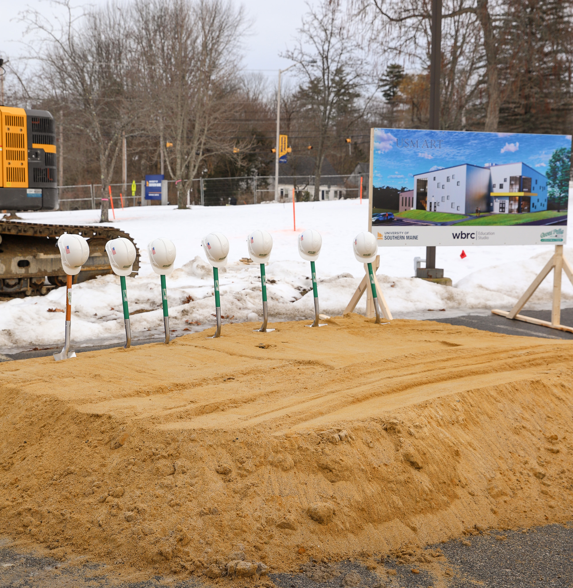 Shovels with hats on them stand in a row awaiting the ground breaking ceremony of the new Arts Building on the USM Gorham Campus.