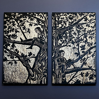 Photo of installed woodcut of tree with children sitting in branches.