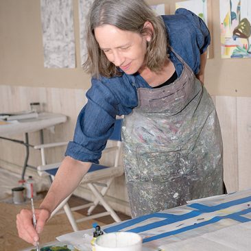 Picture of Andrea Sulzer painting in her studio.