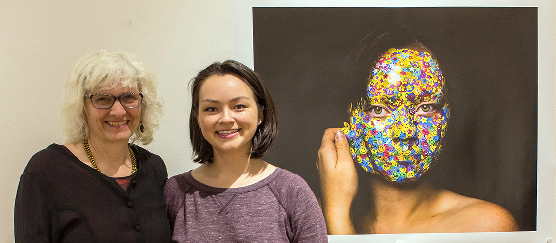 Gallery Director Carolyn Eyer with Juried Show winner student with her photograph "Mask"