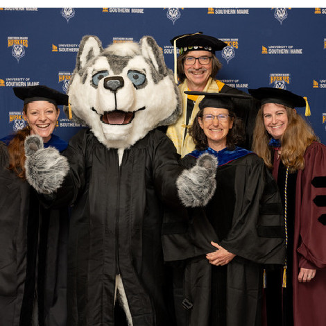 Biology faculty and Champ at 2024 commencement