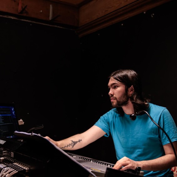 Student working at a sound board.