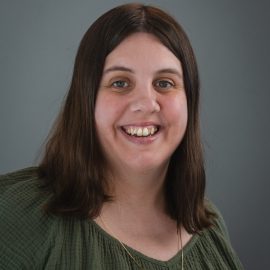 Photo of Lindsay Larsen. Lindsay has brown hair and is wearing a green top.