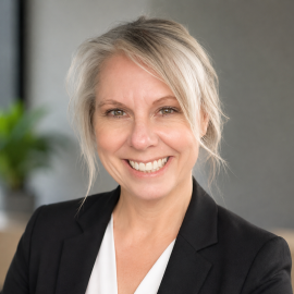 Headshot of Katie Bauer in a black suit,