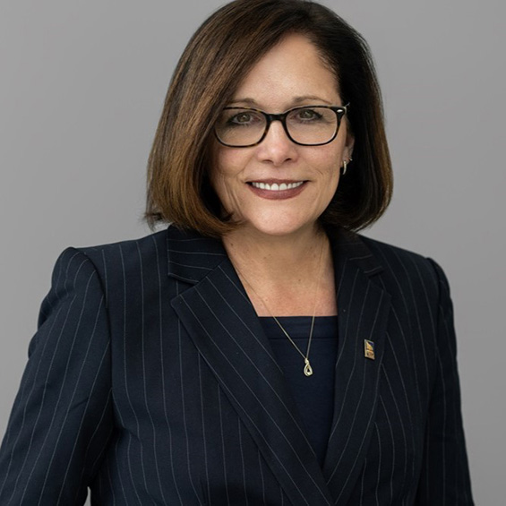 A headshot of President Edmondson wearing a black suit against a solid grey background.