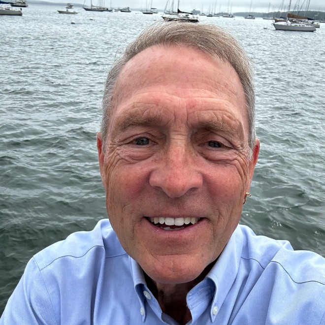 Photo of Mark Steege standing in front of water.