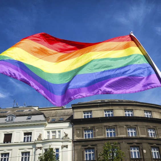 Pride flag flying above buildings