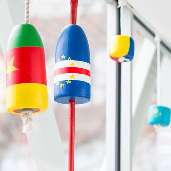 Buoys painted with the designs of different countries' flags.