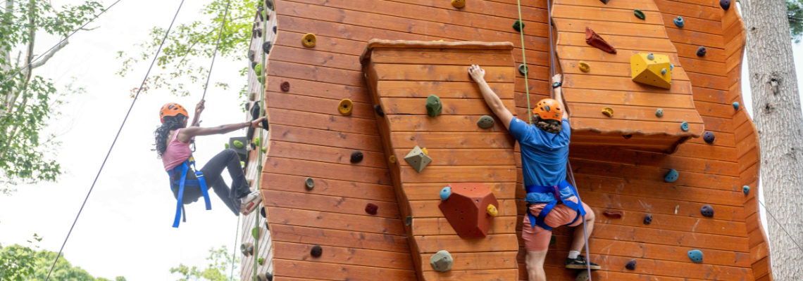 Two Promise Scholars on climbing wall during Immersion Week 2024