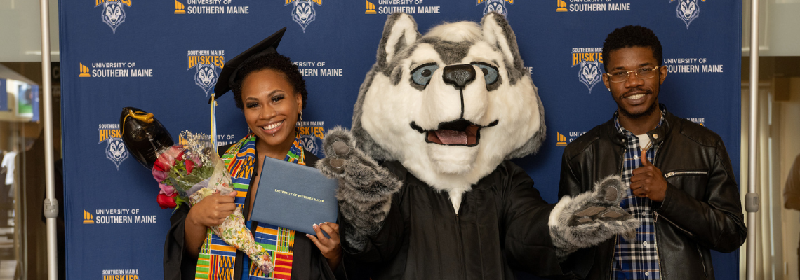 Graduates with Champ the Husky