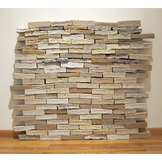 A wall of bricks made out of paper in neutral colors