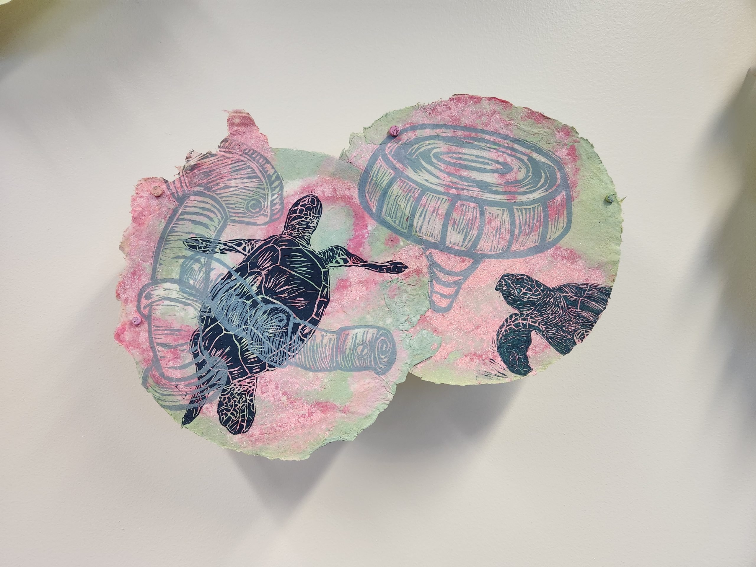 Marilyn Propp, "Small Divers XIV," 2014. Relief print on handmade cotton paper with pulp painting, 10 ¾ x 15 ½ in. Part of "Pulped Under Pressure," 2022. Installation view, Glickman Family Library.