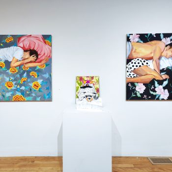 Works by Annie Lee-Zimerle. From left to right: "2:00AM (from the Sleep series)," 2019. Oil on linen 42 x 42 in. "Sleepless Nights (from the Sleep series)," 2022. Accordion book: gouache on paper, marble paper, book board and cloth approximately 21 x 15 x 16 1⁄2 in. (open) | 18 x 15 x 1⁄2 in. (closed). "At Mother’s House (from the Sleep series)," 2019. Oil on linen, 42 x 42 in.  "Hidden Stories," 2023. University of Southern Maine Art Gallery. Photo by Tricia Toms. 