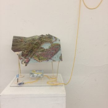 Andrea Atkinson, "Getting There From Here," 2022. Mixed media: repurposed poster, yarn, balsa wood. 11 x 11 x 7 in.