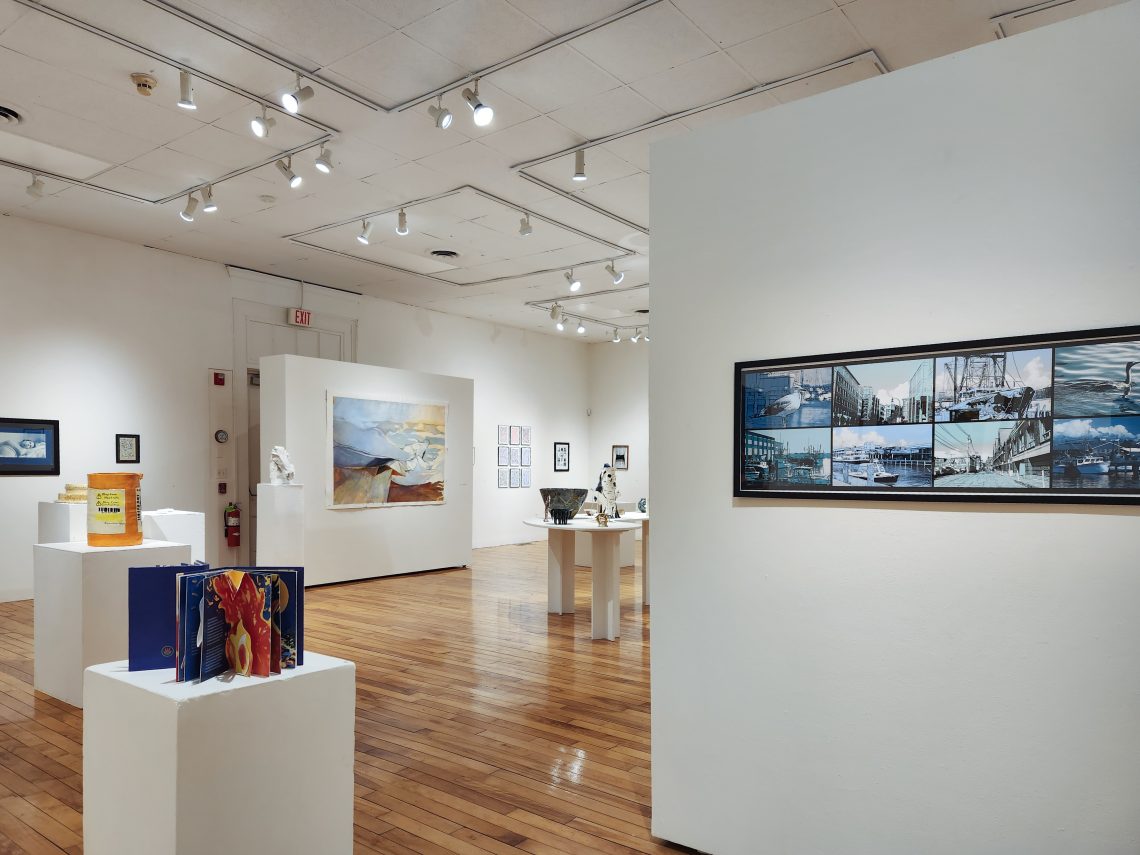 Installation view, "Parallel Convergence: The 2023 University of Southern Maine Juried Student Exhibition," University of Southern Maine Art Gallery. At right: Tabitha Burgess, "Vivid Portland" (detail), 2022. Digital image printed on photographic semi-gloss paper. 45 1/2 x 17 1/2 in.