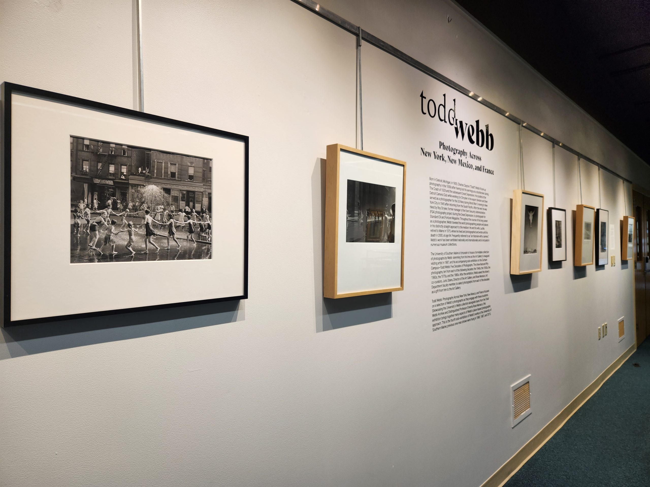 Foreground Left: ""The Circle", LaSalle at Amsterdam, New York," 1946. Silver Gelatin Print. 18 x 22 in. Todd Webb Archive. Installation view, "Todd Webb: Photography Across New York, New Mexico, and France." University of Southern Maine Glickman Library, 2023.
