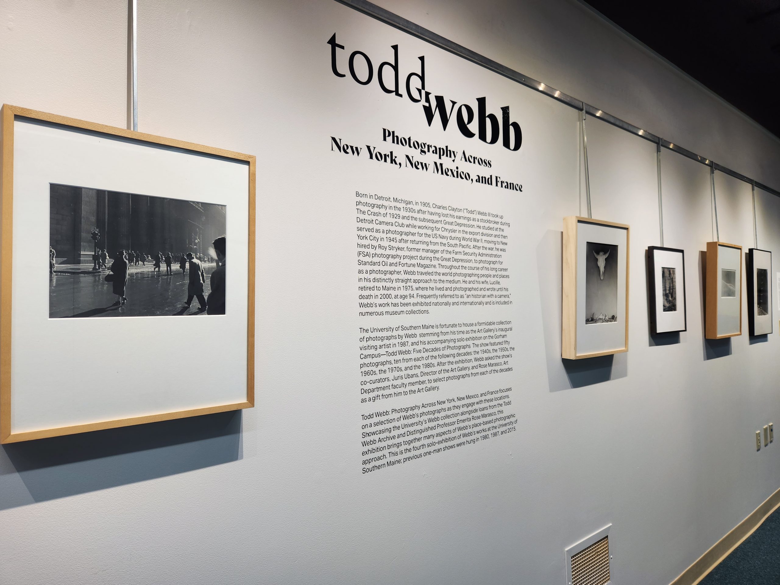 Foreground Left: "Lower Broadway, NY, NY," 1959. Silver Gelatin Print. 16 ¾ x 20 ¾ in. University of Southern Maine Collection. Installation view, "Todd Webb: Photography Across New York, New Mexico, and France." University of Southern Maine Glickman Library, 2023.