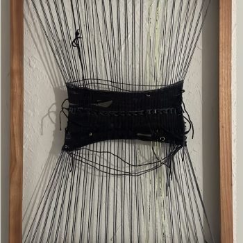 Molly Rea, "The Tension That Holds Us," 2023. Yarn, charms and nails on a frame. 12 x 18 in.