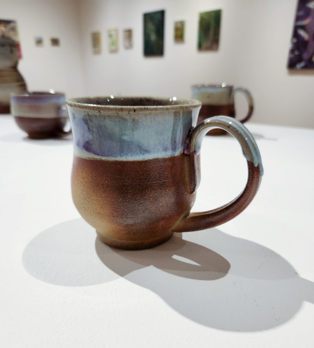 Annika Soderberg "Heaven's Gate Mug I" 2022. Stoneware, 5in. long x 4in. wide x 3in deep. Part of the "2023 Bachelor of Fine Arts and Bachelor of Arts Exhibition," University of Southern Maine Art Gallery.