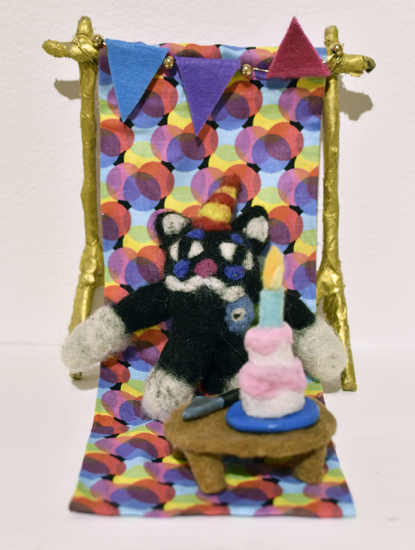Emma Estes, “Murder Mystery Party (Cake will be served)! 2023-2024, Wool roving, felt, hot glue, polymer clay, acrylic paint, wire, beads, fabric, brown paper, & wooden dowels, 6 in. wide x 6 1/2 in. high x 7 1/2 in. deep 
