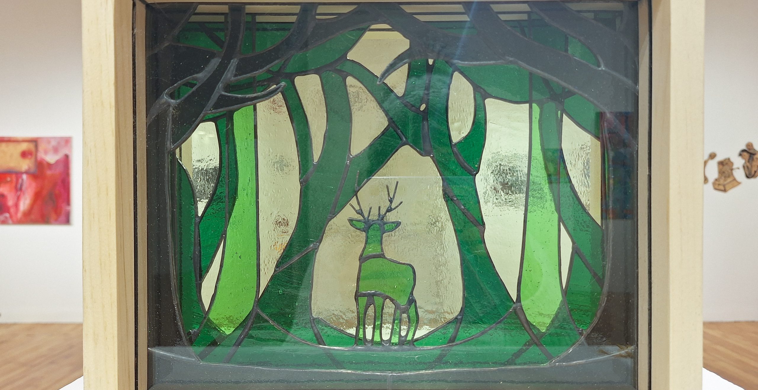 Emily Boone "A Glimpse of Wilderness" stained glass and wood sculpture