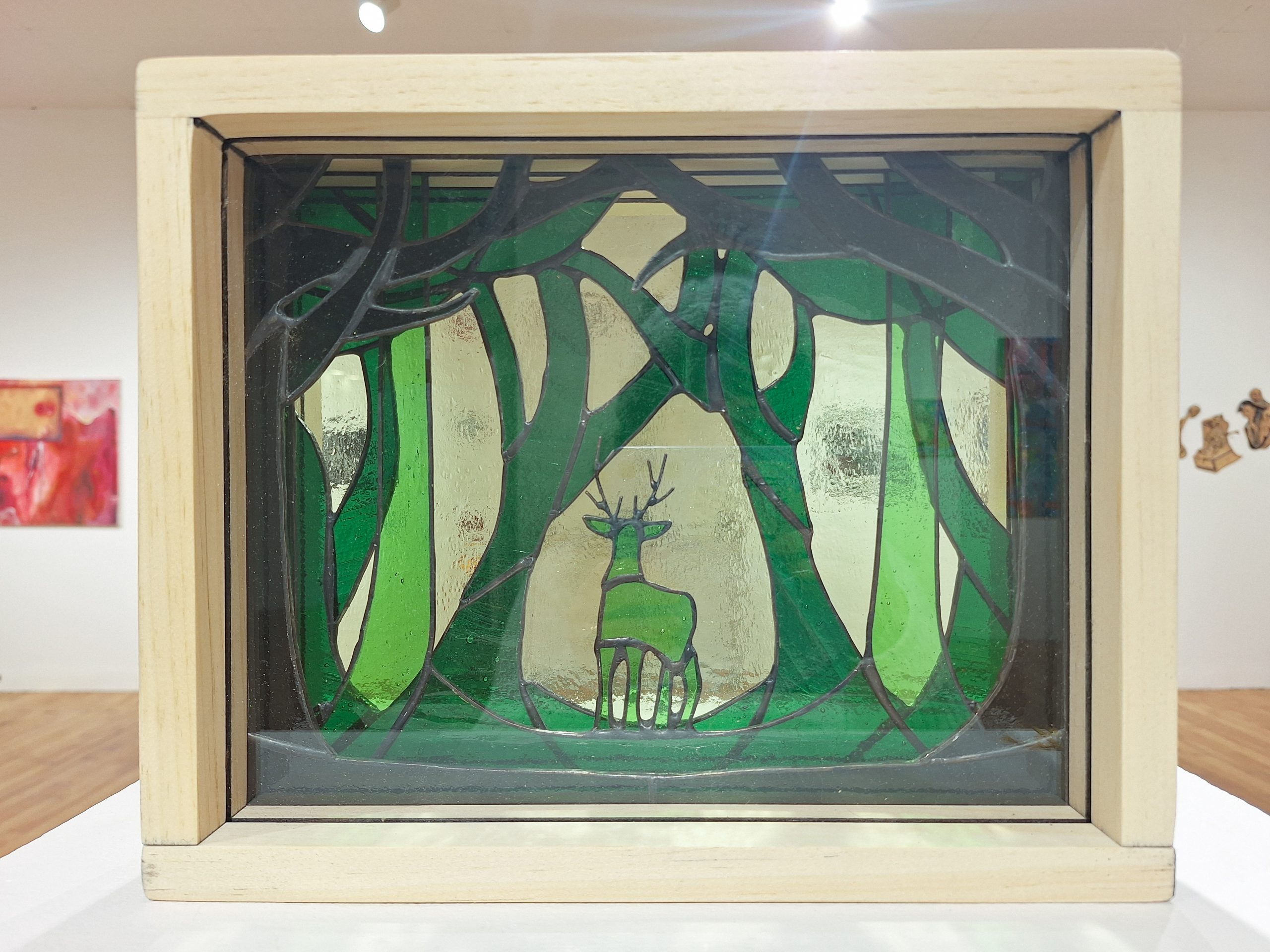 Emily Boone "A Glimpse of Wilderness" stained glass and wood sculpture
