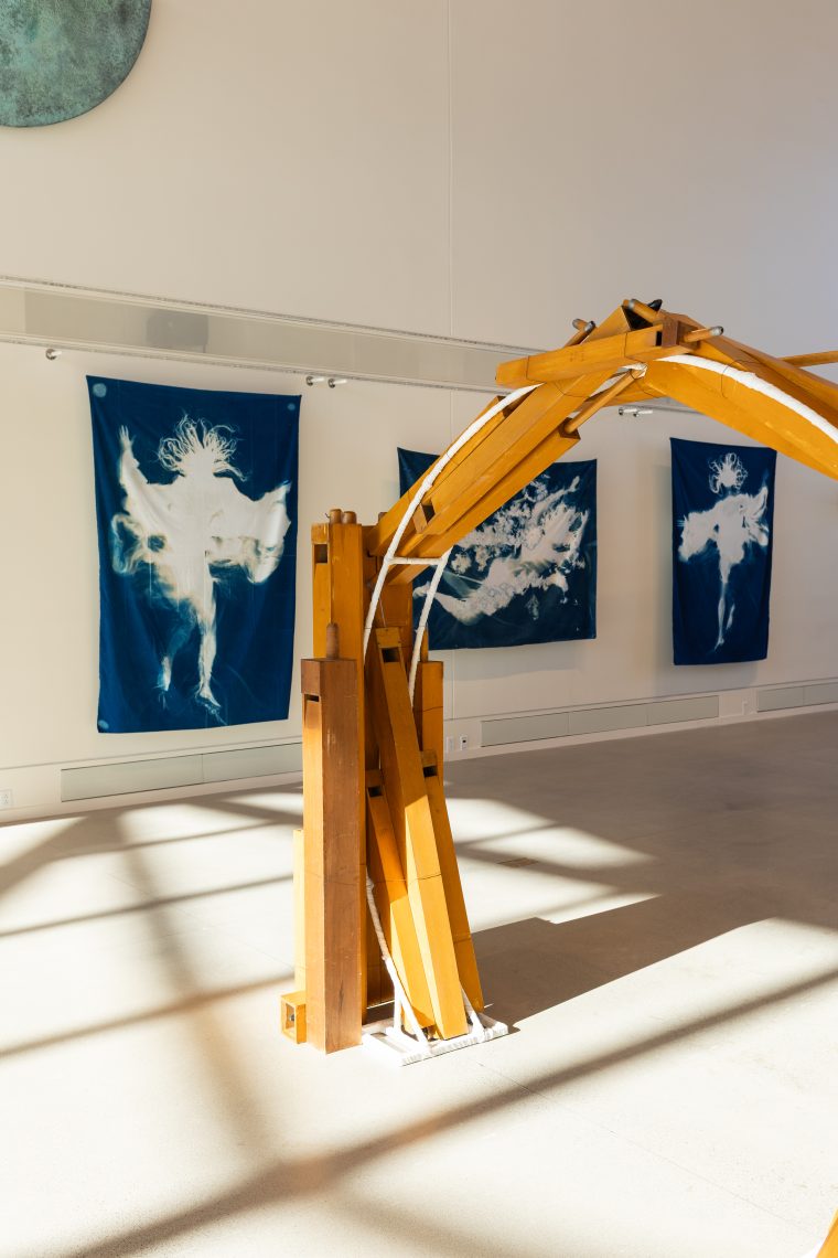 Foreground: work by artist Heather Lyon, "Portal (resonance)," 2026.
Pipeorgan, steel, and cotton. 64 in. high x 64 in. wide x 36 in. deep. Part of "Of Sibyls and Source: Ranges and Ruptures," 2026. Crewe Center for the Arts at the University of Southern Maine. Photo: Marion Earley.