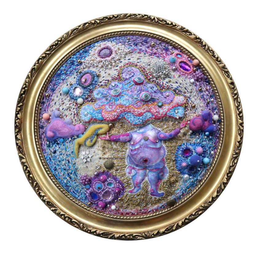 A circular abstraction made of three dimensional embroidery in purples and pinks