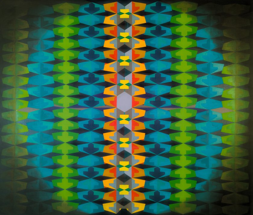 An image of a repeating abstract pattern as if seen through a kaleidoscope in blues, greens, yellows, and oranges.