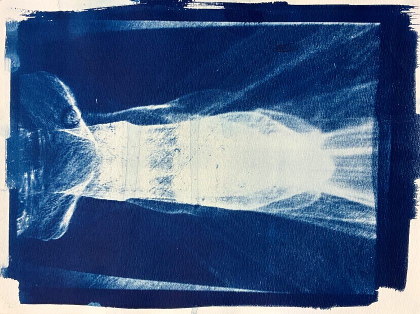 A blurry white horizontal image on a blue ground