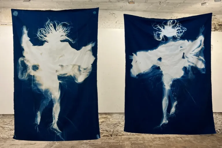 Two dark blue banners that each feature a white humanoid shape.