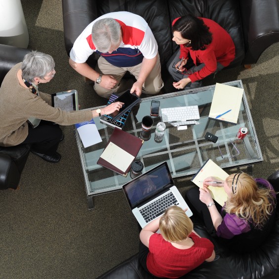 birds-eye-view of 5 seated people working around a table
