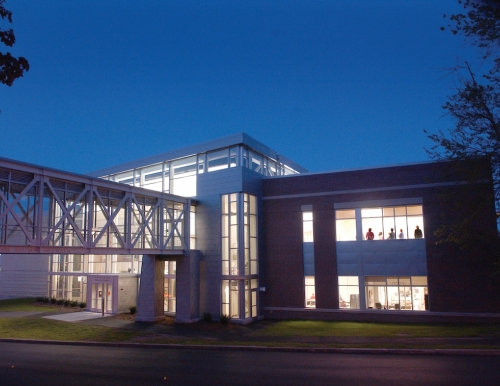 The Abromson Community Education Center lit up at night.
